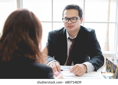 Client and lawyer have a sit down face to face meeting to discuss the legal options available - Shutterstock ID 680714839