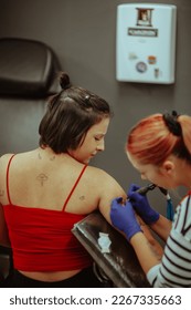 Client is makinf faces while getting tattooed at the studio