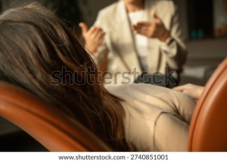 Client participating in hypnotherapy guided by a trained hypnosis therapist. Highlights focused attention, relaxation response, and structured therapeutic guidance