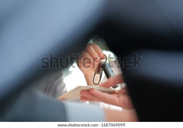 client pay for new\
car. salesman dealer giving key to owner. car sale &\
dealership in auto\
business