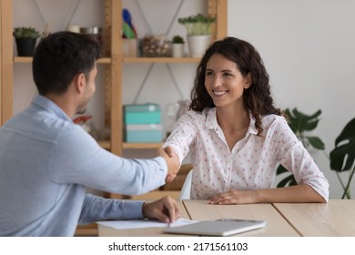 Client and sales manager handshaking after closing profitable deal in company office, recruitment concept. Attractive Hispanic position candidate and HR manager shaking hands after successful hiring - Powered by Shutterstock