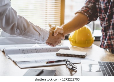 Client Shaking Hands With Contractor After Confirm Blueprint To Renovate House.