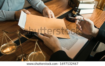 Client is submitting information on the paper of the prosecution document to the lawyer.