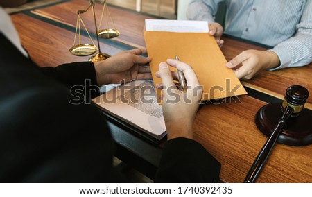 Client is submitting information on the paper of the prosecution document to the lawyer.