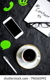client support service workdesk with contact us signs and mobile