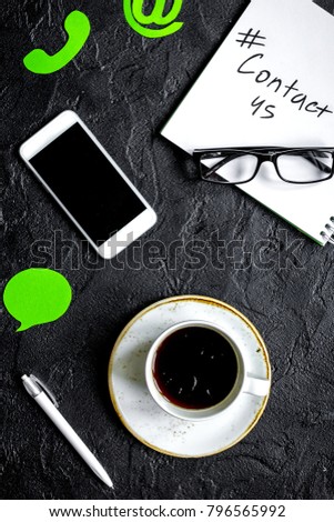 client support service workdesk with contact us signs and mobile
