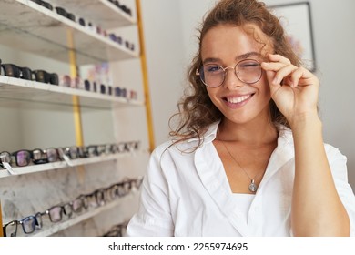Client Woman At Eyeglasses Store Portrait. Cheerful Female Model In Fashion Eye Glasses With Natural Face Makeup Smiling at Shop. Good Vision Concept