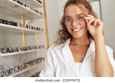 Client Woman At Eyeglasses Store Portrait. Cheerful Female Model In Fashion Eye Glasses With Natural Face Makeup Smiling at Shop. Good Vision Concept - Powered by Shutterstock