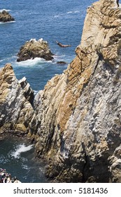 Cliff Diving In Acapulco, Mexico With Two Divers In The Air At The Same Time