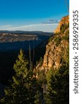 The cliff face of Bunsen Peak illuminated by the setting sun, Ye