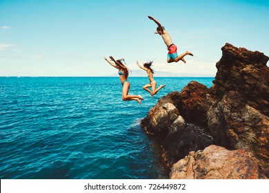 Cliff jumping into the ocean, summer fun adventure lifestyle