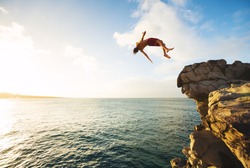 Cliff Jumping Into The Ocean At Sunset, Outdoor Adventure Lifestyle