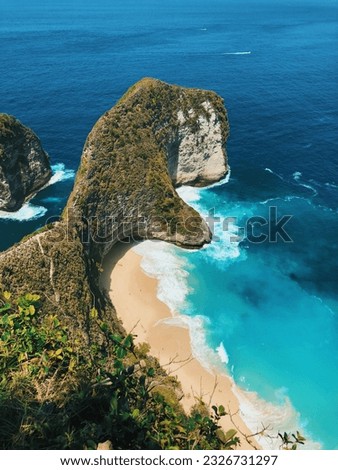 Cliff on a beautiful beach with blue sea water