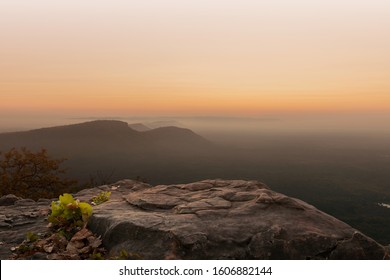 Cliff Stone Located Part Of The Mountain Rock On The Top Hill With Mountain View At Sun Rise Time.