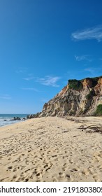 cliff tropical beach with exuberant nature. Lush green vegetation on the shore, in Trancoso in district of Porto Seguro, Brazil. Stone rock cliff landscape like colorful canyon, - Shutterstock ID 2191803805