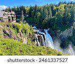 Cliff view of Snoqualmie Falls in Seattle Washington with top view of falls in spring and resort overlooking the falls.