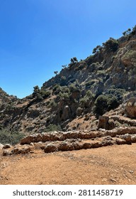 Cliffs above the monastery
Steep cliffs and terraced ruins surround Katholiko Monastery, emphasizing its secluded location within the dramatic limestone gorge.