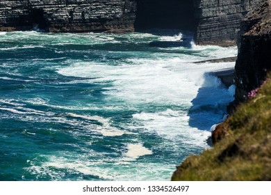 Cliffs of Loop Head, Kilbaha, Co. Clare, Ireland. Unique geological rock formations has formed over millions of years due to water erosion by the crashing waves of the North Atlantic Ocean.