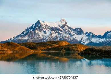 Cliffs of Los Kuernos reflection during sunrise at Lake Pehoe in National Park Torres del Paine, Patagonia, Chile
