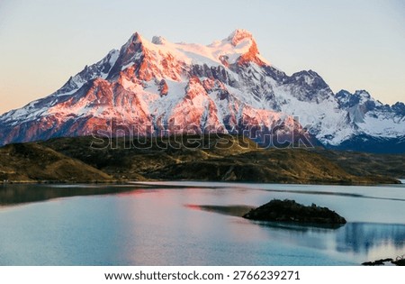 Cliffs of Los Kuernos reflection during sunrise at Lake Pehoe in National Park Torres del Paine, Patagonia, Chile
