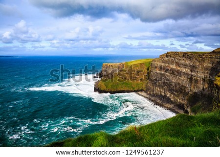 Cliffs of Moher, Burren, County Clare, Ireland. Sea cliffs rise above Atlantic Ocean. View from top cliffs in Galway Bay. Popular tourist attraction. Scenic seascape. Irish rural countryside nature.
