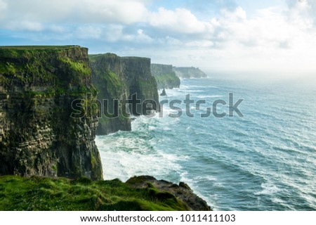 The Cliffs of Moher, Irelands Most Visited Natural Tourist Attraction, are sea cliffs located at the southwestern edge of the Burren region in County Clare, Ireland.