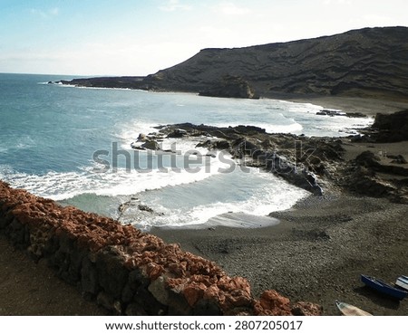Cliffs over El Golfo Beach. Lanzarote Island. Popular touristic attraction.