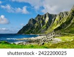 Cliffs rise sharply from the rugged coastline along the Norwegian Scenic Route Andøya, against the backdrop of the North Sea