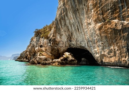 Cliffs and turquoise waters near Grotta del Bue Marino seen from the sea, Sardinia, Italy 