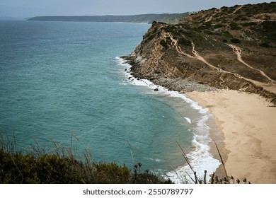 Cliffside beach with turquoise water and rugged terrain. Portugal, Algarve - Powered by Shutterstock