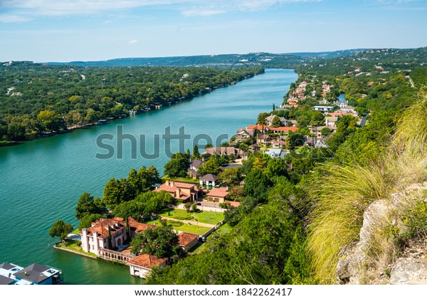 cliffside views over the west lake landscape from\
Mount Bonnell views of colorful rooftops and mansions in nature in\
Austin , Texas , USA