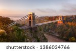 Clifton Suspension Bridge on an autumn morning as the sun rises and breaks through the clouds
