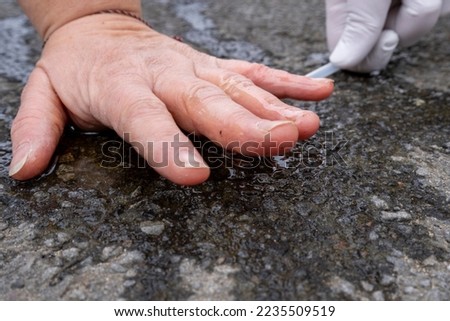 Climate activist stuck her hand on asphalt.