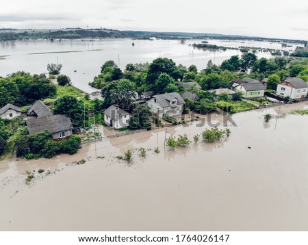 Climate change and the effects of global warming. Flooded houses, streets, farms and fields after heavy rains. Environmental natural disaster. Concept of global catastrophes in the world