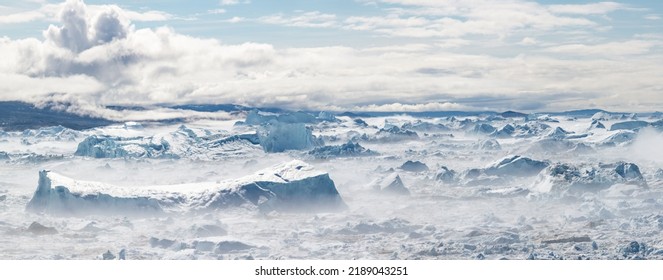 Climate change and global warming. Icebergs from a melting glacier in Ilulissat Glacier, Greenland. The icy landscape of the Arctic nature in the UNESCO world heritage site. - Shutterstock ID 2189043251