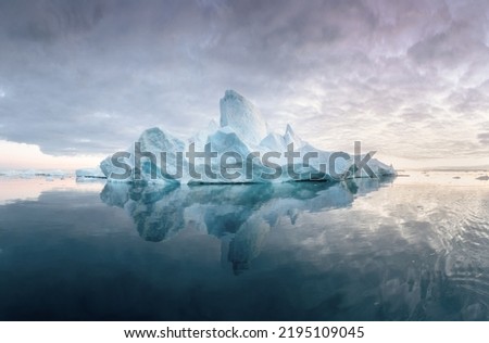 Climate change and global warming. Icebergs from a melting glacier in Greenland. The icy landscape of the Arctic nature in the UNESCO world heritage site. Summer season