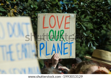 Climate change protest with focus on sign with words 