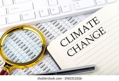 Climate Change Text On The Notebook With Chart, Magnifier,keyboard And Pen