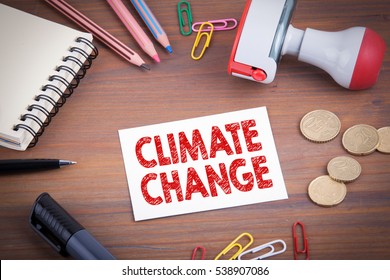 Climate Change. Wooden Office Desk With Stationery, Money And A Note Pad