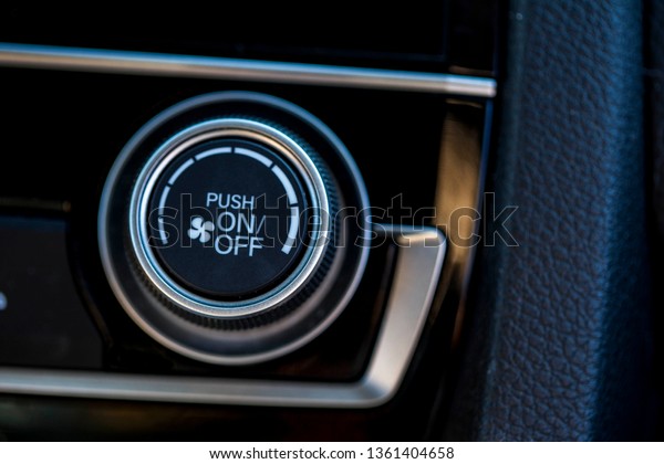 A climate\
control knob in the interior of a\
car.