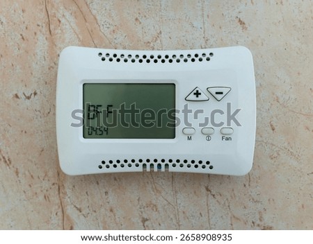 Climate control system control panel mounted on the wall in the off state.