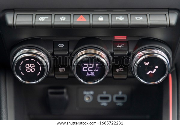 climate control unit in the\
car, circular climate control buttons with digital display in\
modern