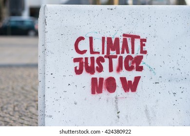 Climate Justice Now Sign Painted On Concrete Wall