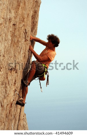 Similar – Rock climber clinging to a cliff.