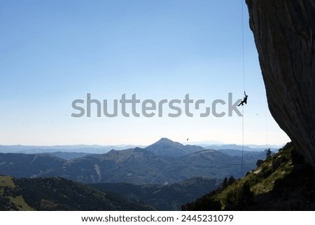 A climber ascends a rope on the cliffs of Ceuse, a mountain in the Alpes Maritimes, Haute Alpes, France, Europe