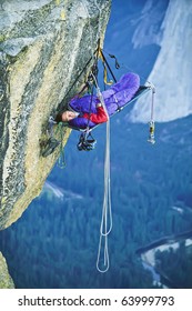 Climber Asleep In His Shelter On The Edge Of A Sheer Rock Wall.