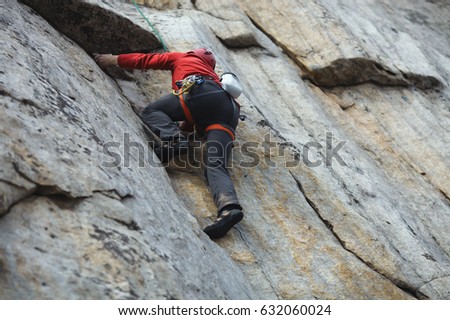 The climber climbs the rock wall. Competitions in rock climbing.
