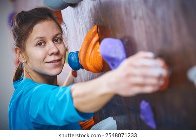 Climber engages in bouldering activity at indoor climbing facility during training session - Powered by Shutterstock