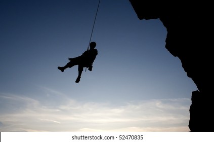 climber hanging on rope