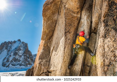 Climber In High Mountain Climbing Rock Chimney